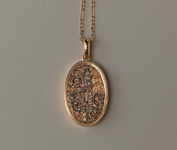 gold locket with the initial A in 