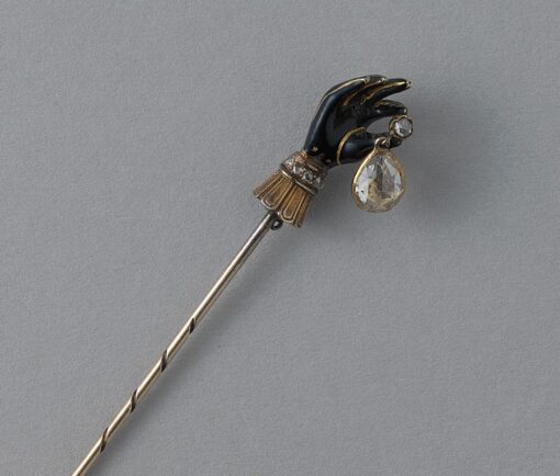 gloved hand pin with diamond