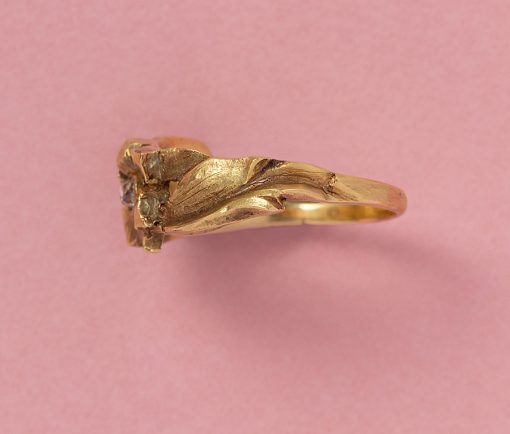 An 18 carat yellow gold Art Nouveau ring in the shape of a flower with a rose cut diamond in the middle, the shank leaf-shaped. French import mark. weight: 4.93 grams ring size: 18.5 mm / 8 1/4 US width: 0.9 cm