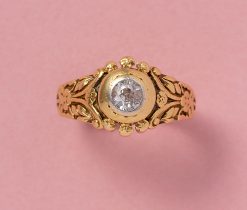 This 18-carat gold ring features an old-cut diamond (app. 0.25 carat) secured in a substantial, white gold bezel setting. The ring's shank is intricately decorated with floral and ribbon motifs. France, circa 1920, numbered: 5721. We see clover, roses, forget-me-nots – please let us know what you see! weight: 8.17 grams ring size: 17.75 mm / 7.5 US