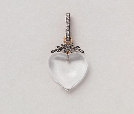 an antique rock crystal heart shaped pendant with silver and gold set with diamond
