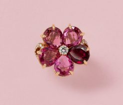 An 18-karat gold flower ring set with 5 pear cut pink and red tourmalines (app. 8.5 crt.) and in the heart of the flower a brilliant cut diamond, and in the shank a leaf shaped decoration set with diamonds, (25 diamonds app. 0.5 ct. G-I/VS-SI, signed and numbered: Bulgari, master mark: 1970AL, collection: Mediterranean Eden, circa 2020, with original case. weight: 12.75 g ring size: 17 mm / 6.5 US / 52 size: 2.2 cm
