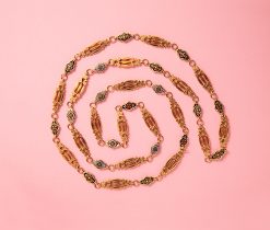 A long 18 carat gold sautoir with gold links with triple bars alterneted with shorter gold links all decorated with different colored enamel on each side, France, circa 1820-1830, hallmarked with the ram's head for France 1819-1838 and a French makers mark. Measuring mark: 5 pointed star - 5 pointed star/Christmas bell with B&B/D in the center. weight: 50.27 g length: 128 cm width: 1 cm