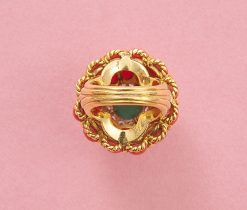 An 18k yellow gold cake ring with two rows of 12 oval cabochon-cut corals around it. The bottom row has slightly larger corals and a gold border between the corals. On top is a white gold flower set with twelve brilliant-cut diamonds, topped with a round cabochon cut turquoise set in six yellow gold claws. At the bottom of the ring is a border of twisted gold wire and two gold balls on the shank, which consists of five bands tapering from wide to narrow, numbered: 2553, circa 1960. weight: 27 g ring size: 16+ mm / 5 1/2 US dimensions: 27.2 (ring width) x 24 (height) mm shank width: 4.2 - 12 mm
