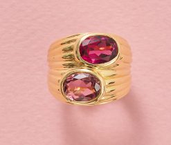 An 18k yellow gold band ring set with 2 oval faceted tourmalines (app. 1.44 ct), one light pink and one bright pink, signed Bulgari, circa 1990s. weight: 15.7 g ring size: 15.5 mm / 4 3/4 US / EU 49