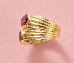 An 18k yellow gold band ring set with 2 oval faceted tourmalines (app. 1.44 ct), one light pink and one bright pink, signed Bulgari, circa 1990s. weight: 15.7 g ring size: 15.5 mm / 4 3/4 US / EU 49