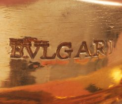 An 18k yellow gold band ring set with 2 oval faceted tourmalines (app. 1.44 ct), one light pink and one bright pink, signed Bulgari, circa 1990s. weight: 15.7 g ring size: 15.5 mm / 4 3/4 US / EU 49