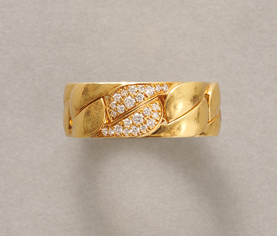 An 18-carat gold ring with a chain link set with diamonds, signed and numbered: Cartier, NV9891, model Dona. weight: 15.85 g ring size: 17.5 mm / 7 1/4 US / 55 width: 0.8 cm