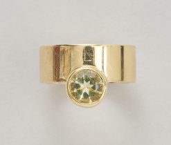 A 14-karat gold band ring with a round faceted citrine on the side, signed: Hans Appenzeller. Weight: 11.6 g Ring size: 17–17.25 mm / 6 1/2–6 3/4 US. Width: 8 mm