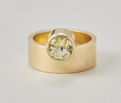 A 14-karat gold band ring with a round faceted citrine on the side, signed: Hans Appenzeller. Weight: 11.6 g Ring size: 17–17.25 mm / 6 1/2–6 3/4 US. Width: 8 mm