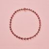 Een 18-karaats rosé gouden collier bezet met 40 ronde roosgeslepen granaten gezet op rood goud folie aflopend in grootte, Zuid-Frankrijk, circa 1900. gewicht: 19.95 g lengte: 39 cm