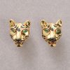 A pair of 18k gold earrings in the shape of panther heads with navette-cut emerald eyes and lacquered spots, signed and numbered: Cartier, 681245, maker’s mark: Société Galbert 1980–2007, model: Massai Pan. weight: 27.36 g dimensions: 2.1 x 1.9 x 1.3 cm