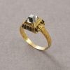 Een Renaissance ring van 19-karaat geel goud bezet met een tafel geslepen diamant (app. 0.9 crt G / Piq) in een hoge, gedecoreerde "doos" zetting met zwarte email in de gegraveerde boogjes, de scheen floraal gegraveerd, vroeg 17e eeuw. gewicht: 9.6 g ringmaat: 18.25 mm 8 US / 57 breedte: 1.8 - 8.5 mm afmetingen: 9.6 x 10.7 x 6.7 mm De resultaten van het metallurgisch onderzoek door CIRAM adhv ICP en SEM op het goud zijn bekend: - 19 karaat goud - geen tekenen van moderne toevoegingen in de legering (zoals cadmium, dat doorgaans in modern goud wordt aangetroffen) - natuurlijke verweringsfasen aan het oppervlak die de ouderdom bevestigen.